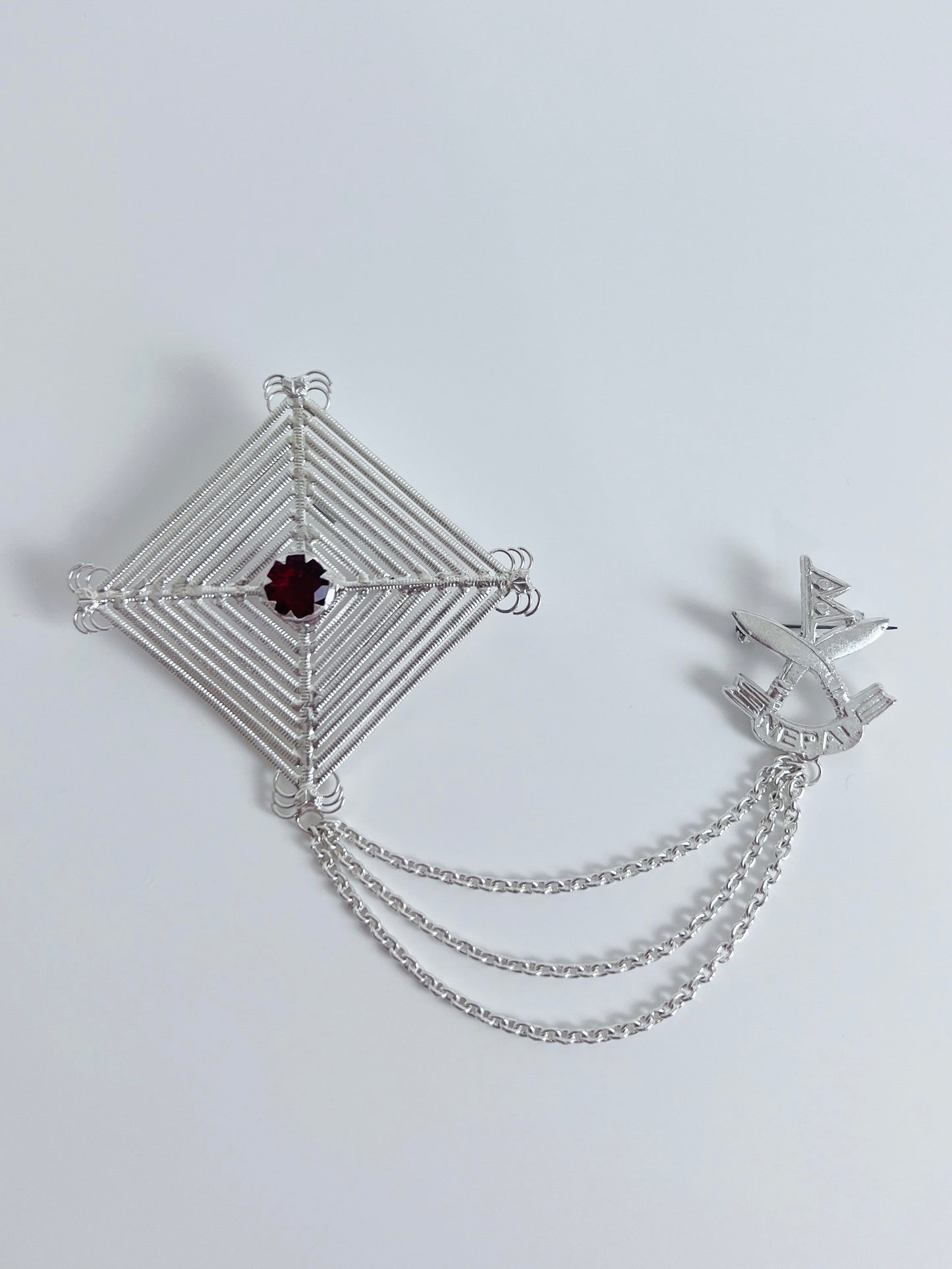 Silam Sakhma & Khukuri Handcrafted Pure Silver Brooch – Red Stone